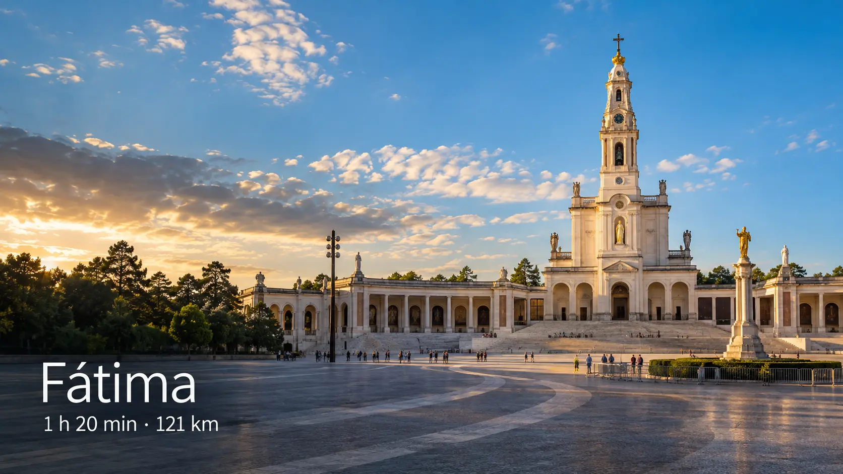 The basilica tower and colonnade of the Sanctuary of Fátima in golden evening light