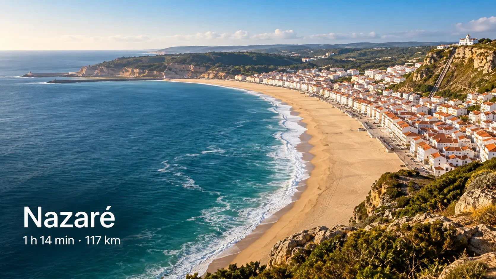The curved sandy beach of Nazaré with white houses and the Atlantic from a clifftop viewpoint